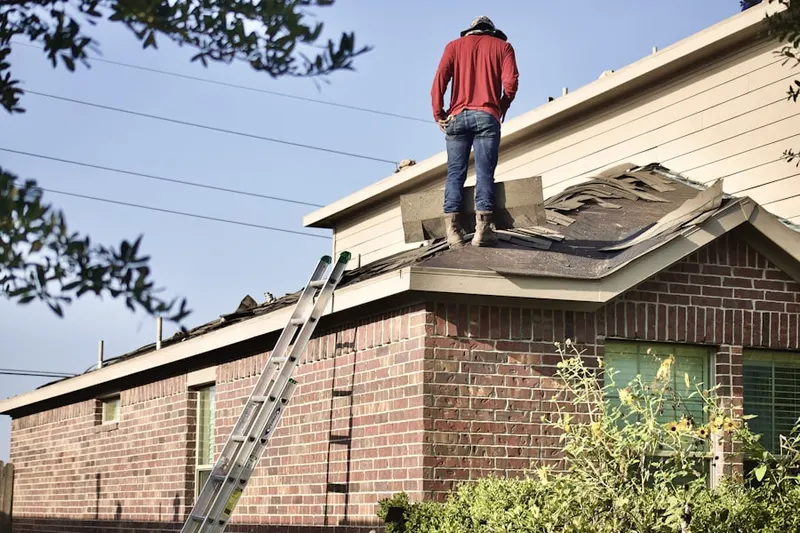 Professional roofer working on a residential roof in Thomas J Dohany Homes